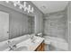 Bright bathroom featuring a double sink vanity, and tiled shower-tub combo at 1064 Wenham Ln, Lawrenceville, GA 30044