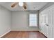 Cozy bedroom with a ceiling fan, closet and warm hardwood floors at 1064 Wenham Ln, Lawrenceville, GA 30044