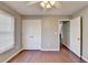 Bedroom features a ceiling fan, closet and warm hardwood floors at 1064 Wenham Ln, Lawrenceville, GA 30044