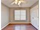 Cozy bedroom with a ceiling fan, closet, hardwood floors and window at 1064 Wenham Ln, Lawrenceville, GA 30044