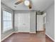 Bedroom features a ceiling fan, closet and warm hardwood floors at 1064 Wenham Ln, Lawrenceville, GA 30044