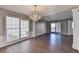 Open dining area with hardwood floors, chandelier, and large windows at 1064 Wenham Ln, Lawrenceville, GA 30044