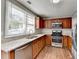 Charming kitchen equipped with stainless steel appliances, granite countertops, and warm wood cabinets at 1064 Wenham Ln, Lawrenceville, GA 30044