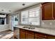 Updated kitchen features granite countertops, stainless steel appliances, and view to the backyard at 1064 Wenham Ln, Lawrenceville, GA 30044