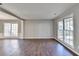 Open living area with hardwood floors, neutral walls, and natural light from large windows at 1064 Wenham Ln, Lawrenceville, GA 30044