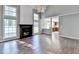 Spacious living area with hardwood floors, fireplace, and large windows with natural light at 1064 Wenham Ln, Lawrenceville, GA 30044