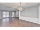 Spacious living room with hardwood floors, neutral walls, and natural light from large windows at 1064 Wenham Ln, Lawrenceville, GA 30044