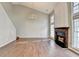 Bright living room featuring hardwood floors, fireplace with mantel, and soaring ceilings at 1064 Wenham Ln, Lawrenceville, GA 30044