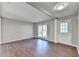 Bright living room featuring hardwood floors and a white entryway door and trim at 1064 Wenham Ln, Lawrenceville, GA 30044