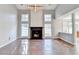 Bright living room boasts a fireplace, vaulted ceilings, a modern chandelier and hardwood floors at 1064 Wenham Ln, Lawrenceville, GA 30044