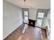 The bright living room includes a fireplace, vaulted ceilings, a modern chandelier and wood floors at 1064 Wenham Ln, Lawrenceville, GA 30044
