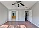Main bedroom has hardwood floors and a view to a bathroom, and a closet on the other side at 1064 Wenham Ln, Lawrenceville, GA 30044