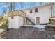 Back of house featuring a new wooden deck, white brick exterior, and a stone foundation at 4326 Newton Cir, Douglasville, GA 30134