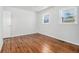 Bedroom featuring hardwood floors, white walls, and natural light from two windows at 4326 Newton Cir, Douglasville, GA 30134