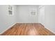 Bright bedroom with hardwood floors, two windows, and white walls and trim at 4326 Newton Cir, Douglasville, GA 30134