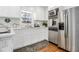 Renovated kitchen featuring stainless steel appliances, white cabinets, countertops, and modern fixtures at 4326 Newton Cir, Douglasville, GA 30134
