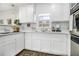 Bright kitchen featuring white cabinets, countertops, stainless appliances, and a window over the sink at 4326 Newton Cir, Douglasville, GA 30134