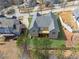 An aerial view of a home displaying its roof, large yard, and surrounding neighborhood under a clear sky at 9089 Hanover St, Lithia Springs, GA 30122