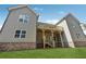 View of the back of the house featuring a deck, patio, neutral siding and brick foundation at 9089 Hanover St, Lithia Springs, GA 30122
