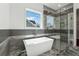 Well-lit bathroom with a modern soaking tub, walk-in shower, and tiled walls, creating a spa-like retreat at 9089 Hanover St, Lithia Springs, GA 30122