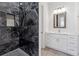 Stylish bathroom with a marble shower, hexagon floor tiles, and modern vanity for a spa experience at 9089 Hanover St, Lithia Springs, GA 30122