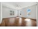 Sunlit bedroom with hardwood floors, ceiling fan, and multiple windows at 9089 Hanover St, Lithia Springs, GA 30122