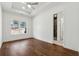 Bedroom featuring hardwood floors, tray ceiling, and a window with neighborhood views at 9089 Hanover St, Lithia Springs, GA 30122
