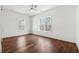 Bedroom features hardwood floors, two windows, and a ceiling fan at 9089 Hanover St, Lithia Springs, GA 30122
