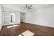 Large bedroom featuring hardwood floors, ceiling fan, and sliding door access to ensuite bathroom at 9089 Hanover St, Lithia Springs, GA 30122