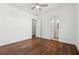Clean bedroom with hardwood floors, white walls, a ceiling fan and natural light at 9089 Hanover St, Lithia Springs, GA 30122