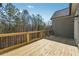 Large wooden deck with wood railing that offers plenty of space for outdoor entertaining at 9089 Hanover St, Lithia Springs, GA 30122