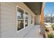A view of the covered porch with wooden columns and stone accents at 9089 Hanover St, Lithia Springs, GA 30122