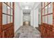 Elegant foyer featuring a decorative tile entryway and beautiful wood and glass doors at 9089 Hanover St, Lithia Springs, GA 30122
