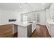 Modern open-concept kitchen with stainless steel appliances, and a fireplace in the adjoining living area at 9089 Hanover St, Lithia Springs, GA 30122