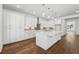 Spacious kitchen boasts white cabinetry, stainless steel appliances, and large center island at 9089 Hanover St, Lithia Springs, GA 30122
