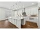 An open kitchen featuring a large island, quartz countertops, and stainless steel fixtures at 9089 Hanover St, Lithia Springs, GA 30122