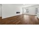 Bright living room featuring hardwood floors, a modern fireplace, white walls and large windows at 9089 Hanover St, Lithia Springs, GA 30122