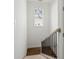Elegant staircase with modern light fixture and wood railing to create a stunning focal point at 9089 Hanover St, Lithia Springs, GA 30122