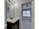 Bathroom featuring a vanity with dark wood cabinets and a large mirror at 933 Carla Pl, Norcross, GA 30093