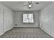 This bedroom features a ceiling fan, a carpet floor, and a window for natural light at 933 Carla Pl, Norcross, GA 30093
