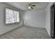 A bedroom with a gray carpet, a window and an exit door at 933 Carla Pl, Norcross, GA 30093