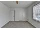 This bedroom has a ceiling fan, carpet and two closets at 933 Carla Pl, Norcross, GA 30093