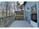 Outdoor deck with wood railing overlooking a wooded area, with access to the house at 933 Carla Pl, Norcross, GA 30093