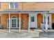 Covered front porch featuring classic brickwork and a decorative front door, creating a welcoming entrance at 933 Carla Pl, Norcross, GA 30093