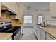 Bright kitchen overlooks the dining area and outdoor deck, and features modern appliances at 933 Carla Pl, Norcross, GA 30093