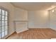 Bright living room with hardwood floors, decorative fireplace, and outdoor access to balcony or patio at 933 Carla Pl, Norcross, GA 30093