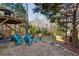 Landscaped backyard with patio and tiered deck surrounded by mature trees at 1898 Woodland Hills Nw Ave, Atlanta, GA 30318