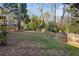 Grassy backyard with wooden fence bordering the property at 1898 Woodland Hills Nw Ave, Atlanta, GA 30318