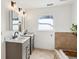 Bathroom with double vanity, marble countertops, and tile surrounding the bathtub area at 1898 Woodland Hills Nw Ave, Atlanta, GA 30318