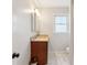 Bright bathroom features a wood vanity with stone counters and decorative lighting at 1898 Woodland Hills Nw Ave, Atlanta, GA 30318